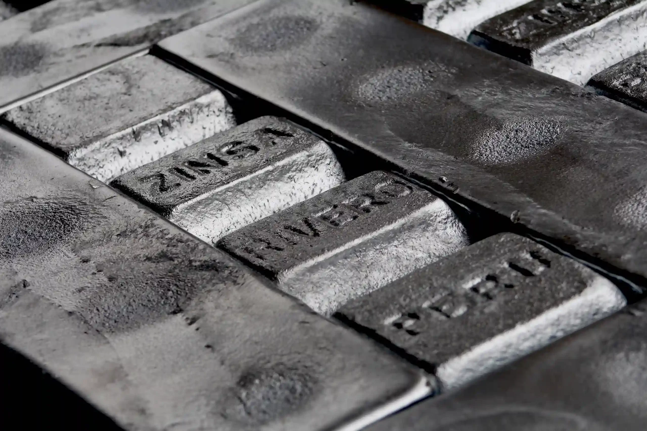Zinc ingots marked with ZINSA and RIVERO names, ready for distribution