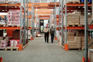 Workers reviewing inventory in an industrial warehouse